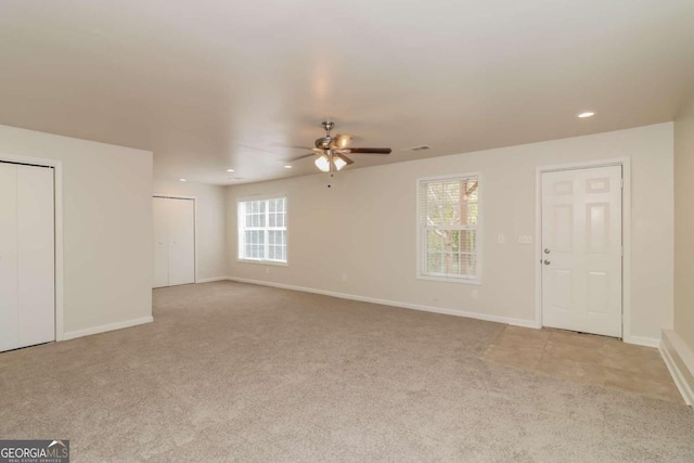 carpeted empty room with ceiling fan