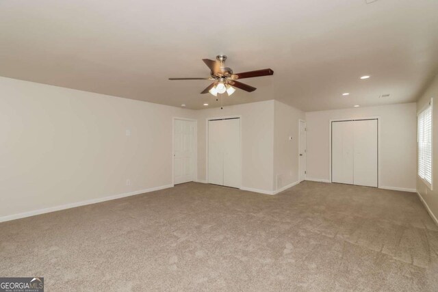 carpeted empty room featuring ceiling fan