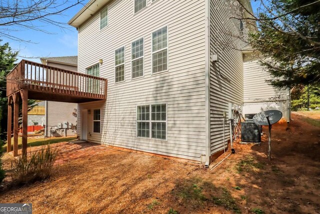 rear view of house with a wooden deck