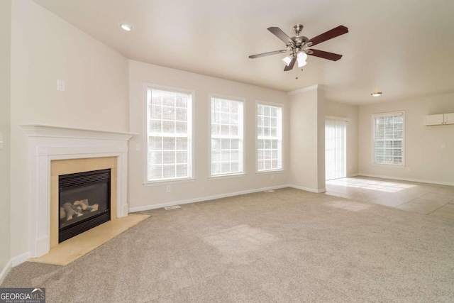 unfurnished living room featuring a wealth of natural light, light carpet, and ceiling fan