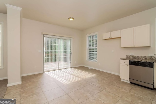 kitchen featuring white cabinets, dark stone countertops, light tile patterned floors, and dishwasher