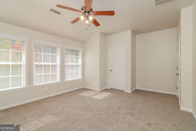 unfurnished bedroom featuring light carpet, ceiling fan, and lofted ceiling