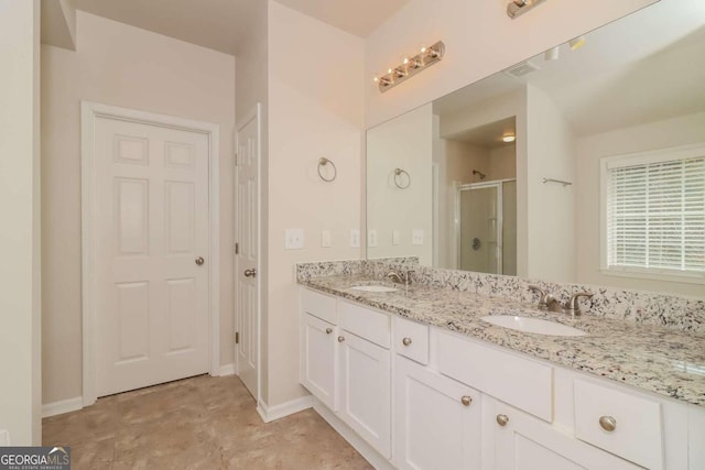 bathroom with vanity and a shower with door