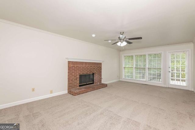 unfurnished living room featuring light carpet, crown molding, and ceiling fan