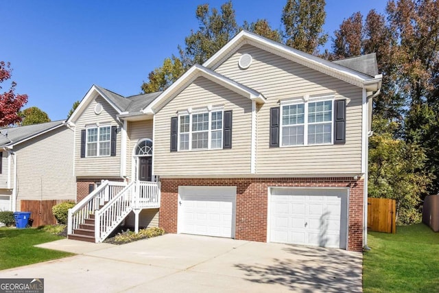 split foyer home featuring a garage and a front yard