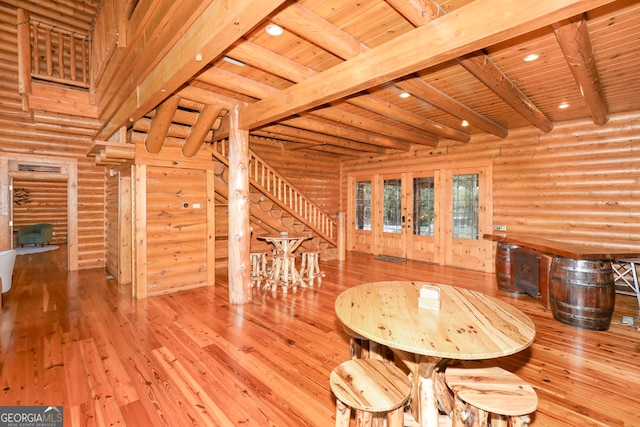 unfurnished dining area with wooden ceiling, light hardwood / wood-style floors, and log walls