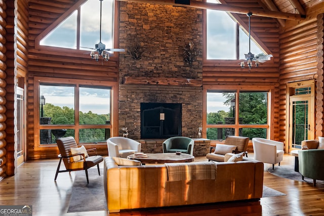 living room with high vaulted ceiling, plenty of natural light, and hardwood / wood-style flooring