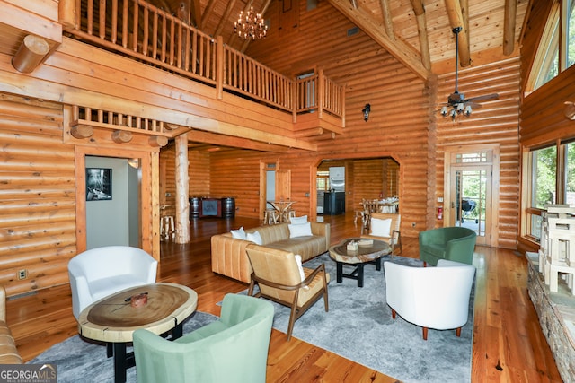 living room with beamed ceiling, high vaulted ceiling, hardwood / wood-style floors, wood ceiling, and log walls