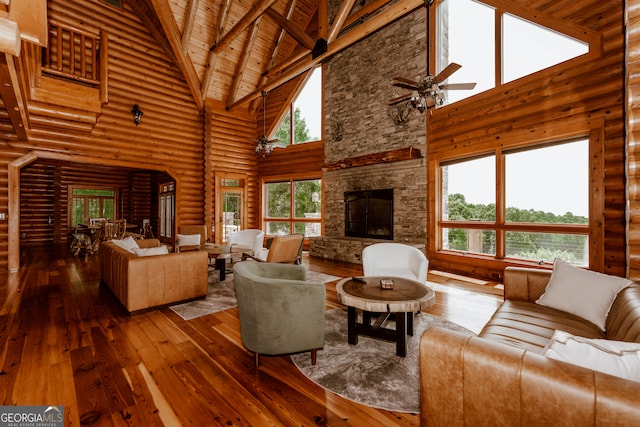 living room with ceiling fan, wooden ceiling, wood-type flooring, and high vaulted ceiling