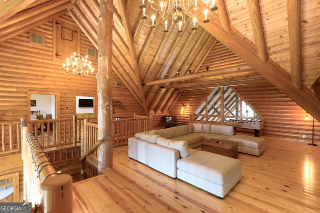 unfurnished living room featuring light hardwood / wood-style floors, wood ceiling, high vaulted ceiling, beam ceiling, and log walls