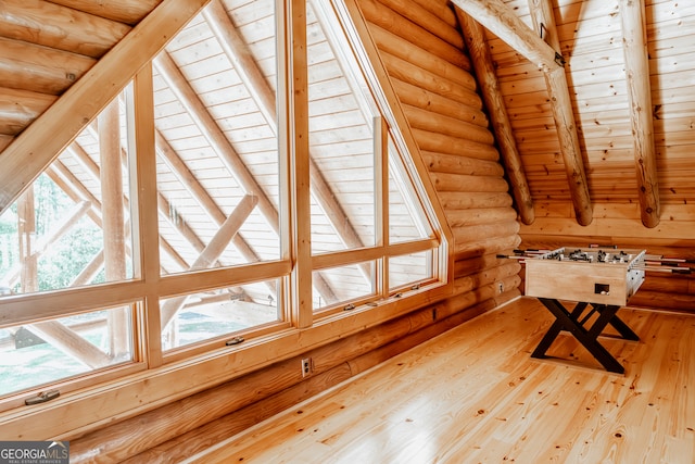 rec room with hardwood / wood-style floors, beamed ceiling, log walls, and wooden ceiling