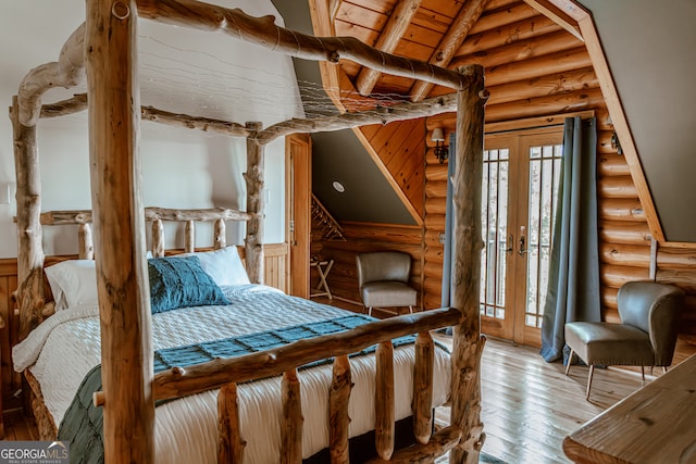 bedroom featuring wooden ceiling, vaulted ceiling with beams, log walls, light wood-type flooring, and french doors