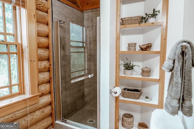 bathroom featuring a shower with door