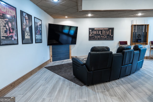 cinema featuring a drop ceiling and wood-type flooring