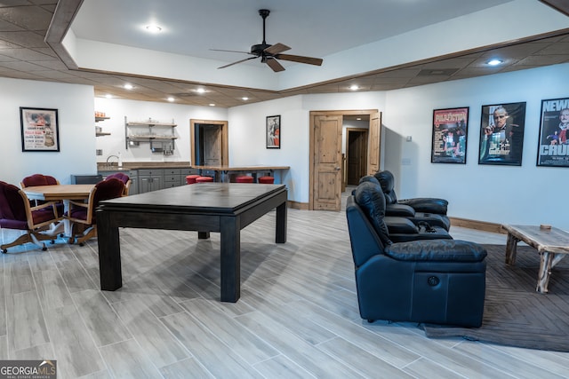 recreation room with sink, ceiling fan, and light hardwood / wood-style flooring