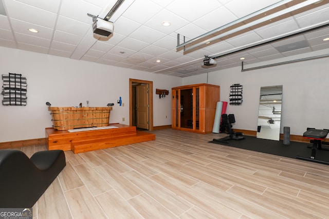 exercise room featuring light wood-type flooring