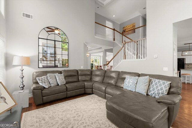 5 Arabian Ave, Alpharetta, GA 30004 - living area featuring baseboards, visible vents, a towering ceiling, wood finished floors, and stairway