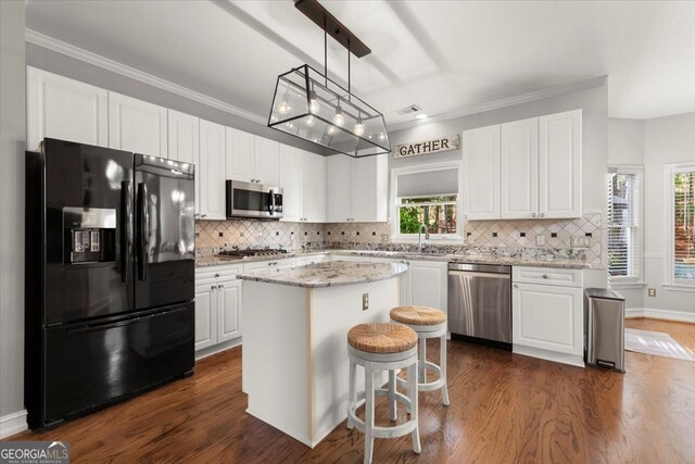5 Arabian Ave, Alpharetta, GA 30004 - kitchen with dark wood-style floors, a kitchen island, white cabinets, and appliances with stainless steel finishes