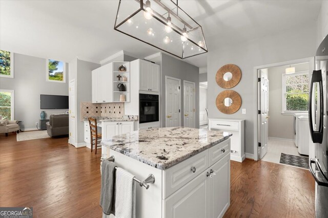 5 Arabian Ave, Alpharetta, GA 30004 - kitchen with black oven, open shelves, white cabinetry, and plenty of natural light
