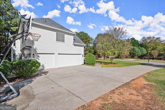 5 Arabian Ave, Alpharetta, GA 30004 - view of property exterior featuring an attached garage, a shingled roof, a yard, and driveway