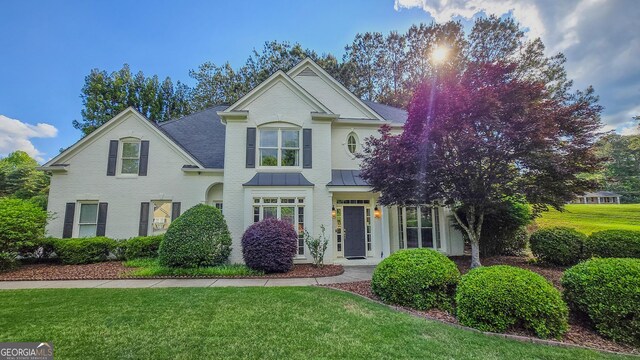 5 Arabian Ave, Alpharetta, GA 30004 - traditional-style home featuring a standing seam roof, brick siding, and a front yard