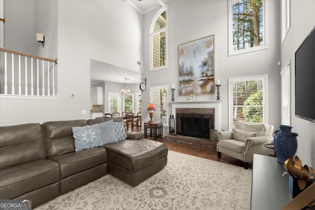 5 Arabian Ave, Alpharetta, GA 30004 - living area featuring a healthy amount of sunlight, wood finished floors, a fireplace, and a high ceiling
