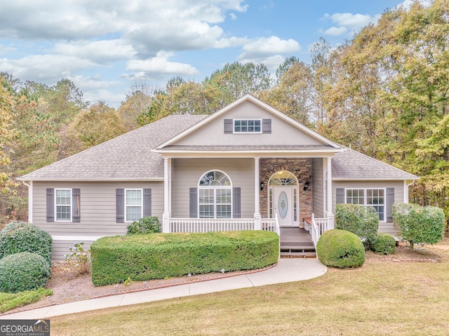 view of front of home featuring covered porch and a front lawn