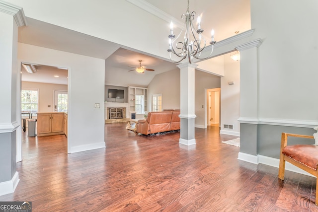 interior space with hardwood / wood-style flooring, ceiling fan, ornate columns, and lofted ceiling