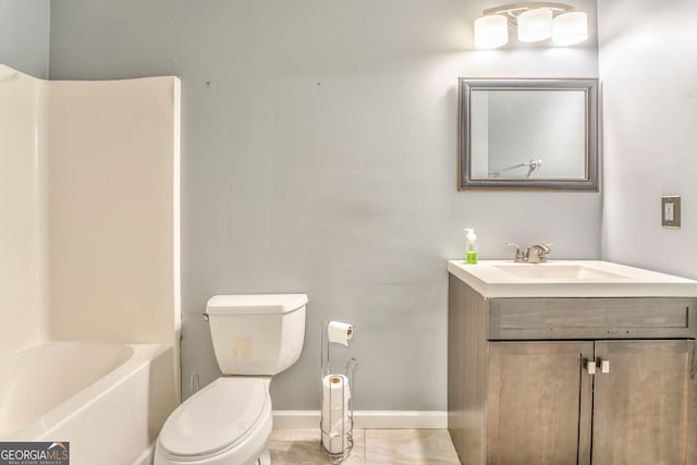 bathroom featuring toilet, vanity, and tile patterned flooring