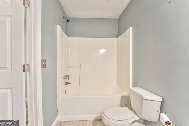 bathroom featuring toilet and  shower combination