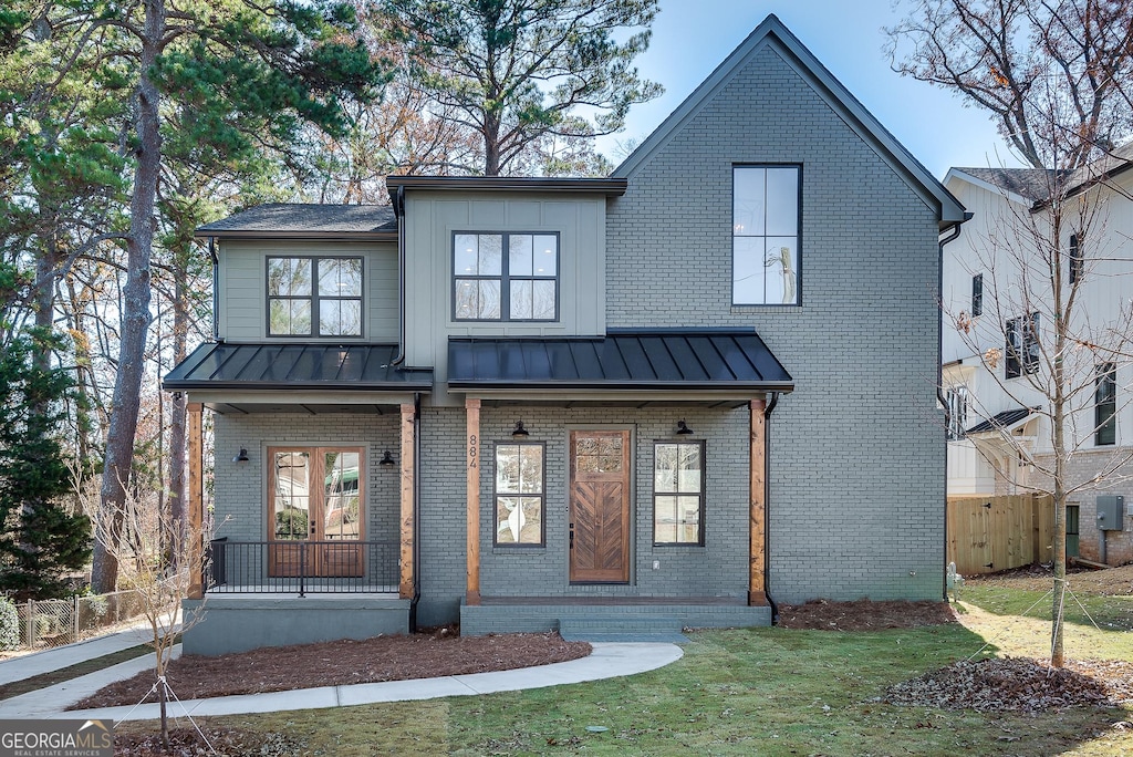 view of front of house with a porch and a front yard