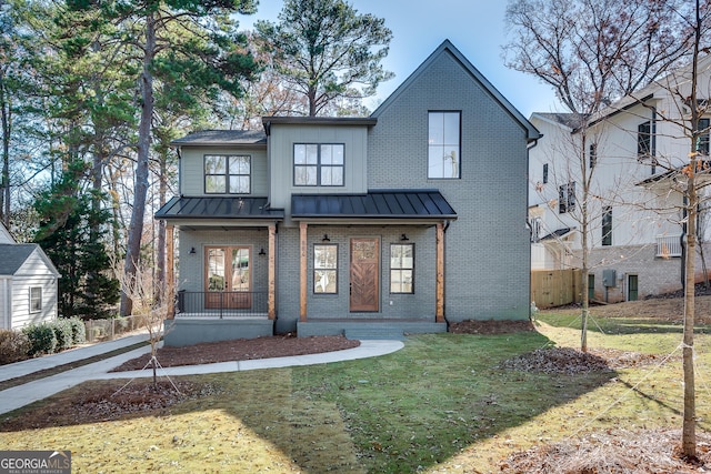 modern farmhouse with a front yard and a porch