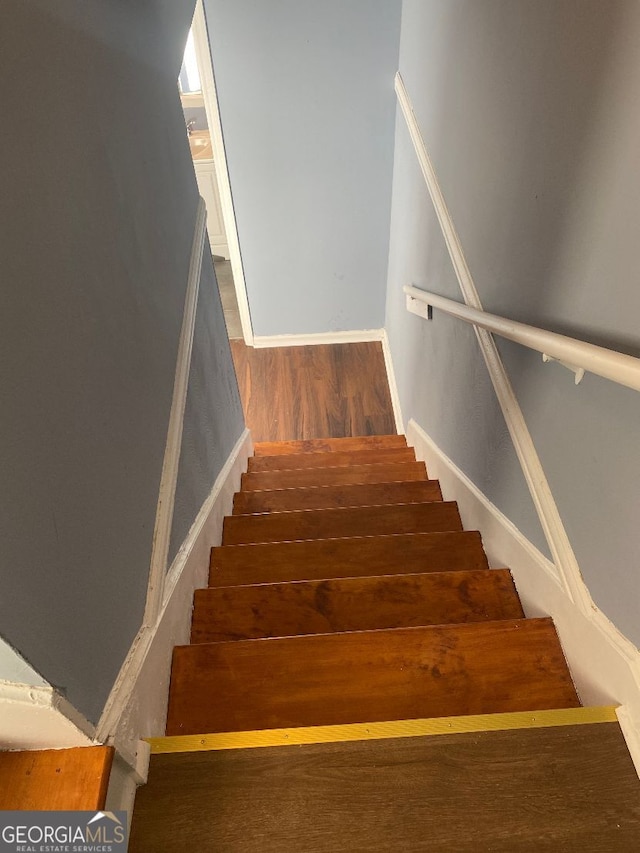 stairs with hardwood / wood-style flooring