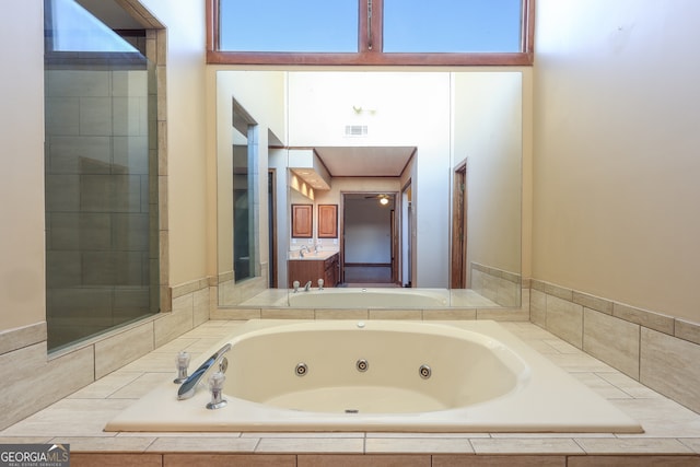 bathroom with tiled bath and a wealth of natural light