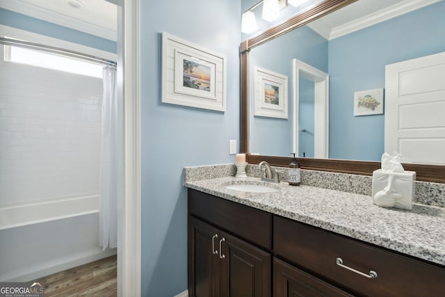 bathroom with hardwood / wood-style floors, shower / bath combo with shower curtain, vanity, and crown molding