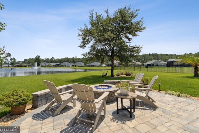 view of patio / terrace with a water view and a fire pit