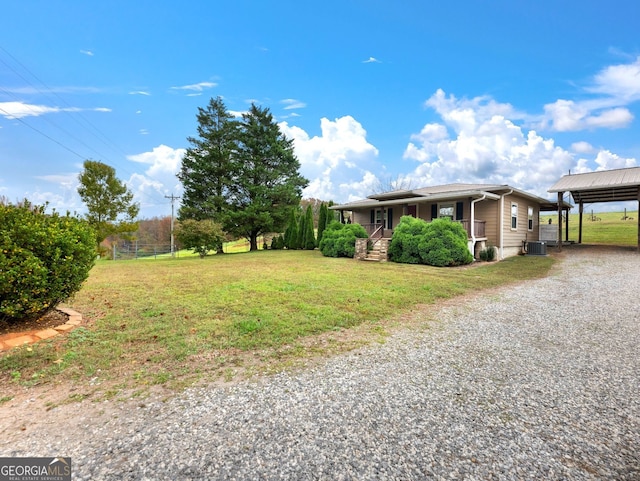 exterior space with covered porch, a carport, central AC unit, and a front lawn