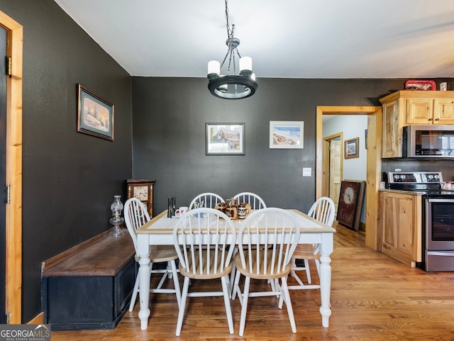 dining area featuring a chandelier and light wood-type flooring