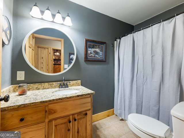 bathroom featuring tile patterned flooring, vanity, and toilet