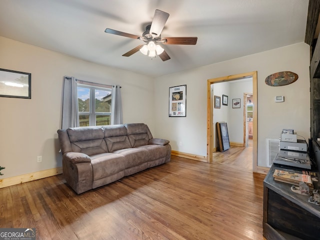 living room with ceiling fan and hardwood / wood-style floors