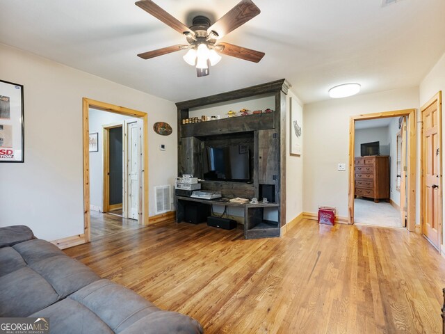 living room with ceiling fan and light hardwood / wood-style floors