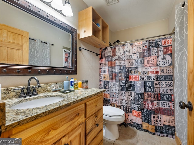 bathroom with tile patterned flooring, a shower with curtain, vanity, and toilet