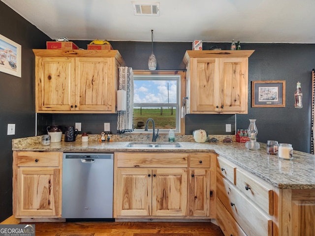 kitchen with dishwasher, light brown cabinets, sink, hanging light fixtures, and light stone counters