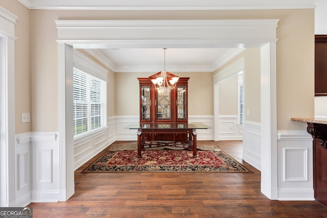 dining room featuring ornamental molding, a chandelier, and dark hardwood / wood-style floors