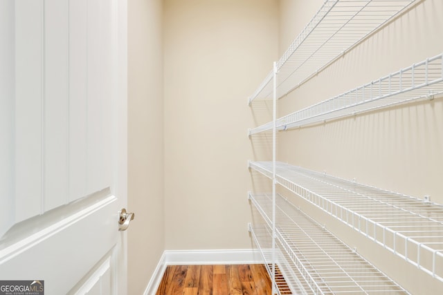 walk in closet featuring hardwood / wood-style flooring