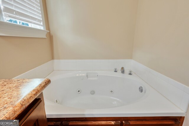 bathroom featuring a bathing tub and vanity