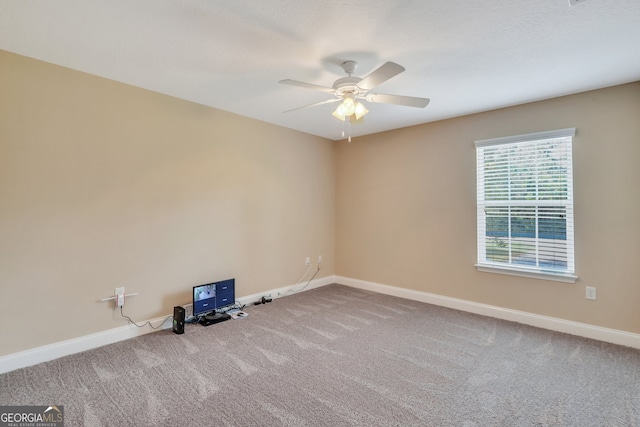 spare room featuring carpet flooring and ceiling fan