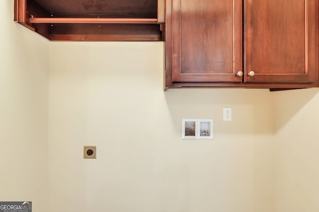 clothes washing area with cabinets, hookup for a washing machine, and electric dryer hookup