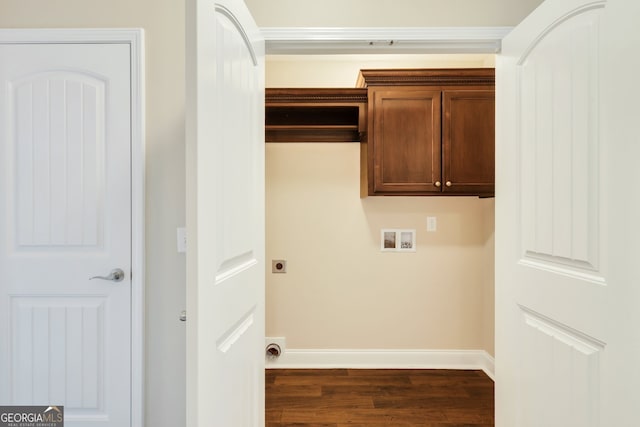 laundry room with dark wood-type flooring, hookup for a washing machine, cabinets, and hookup for an electric dryer