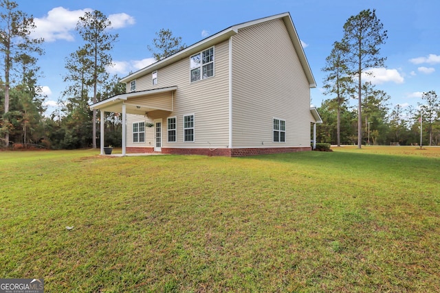 back of property featuring a lawn and a patio area